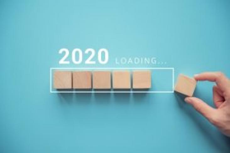 2020 Loading 2020 loading with hand holding blank game board tiles