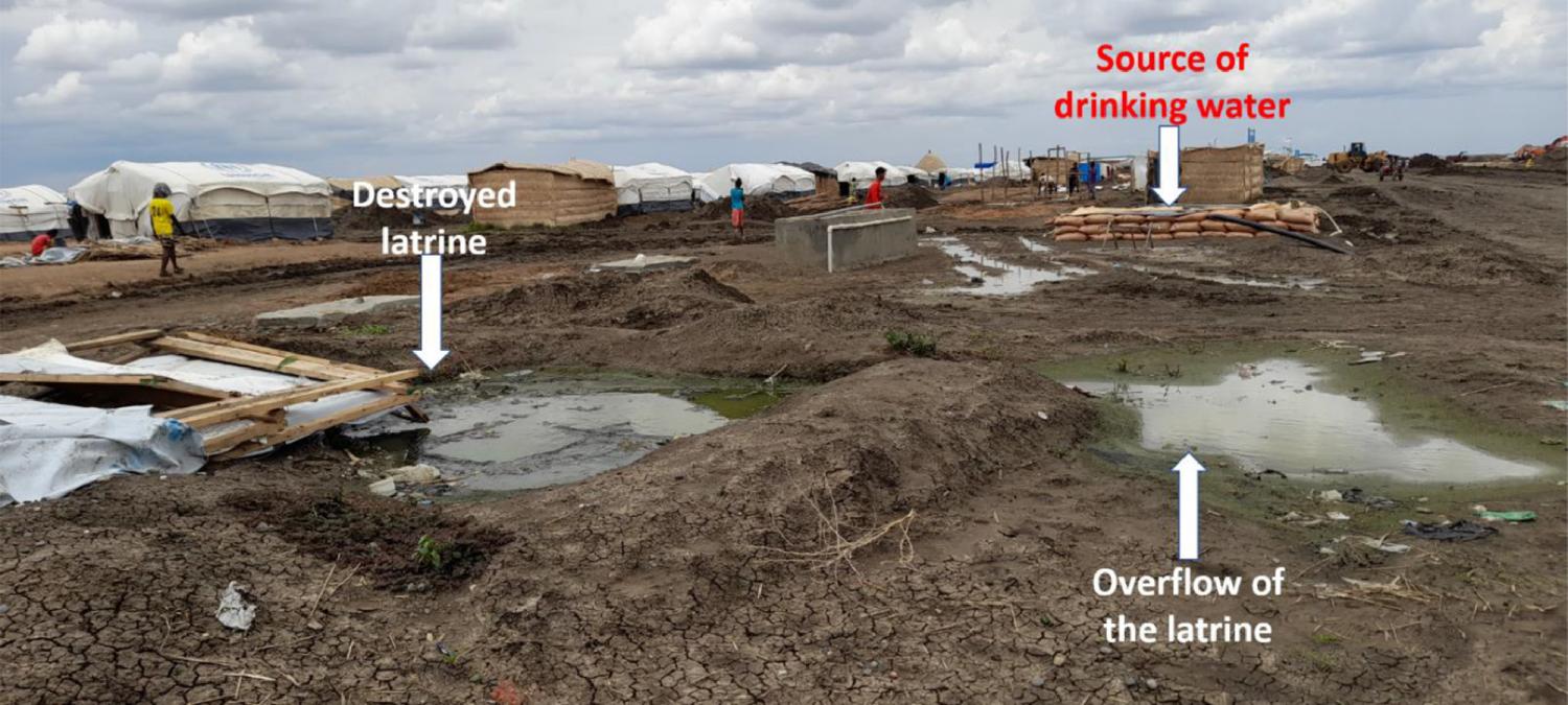 A picture of destroyed and inundated latrine beside the source of drinking water.