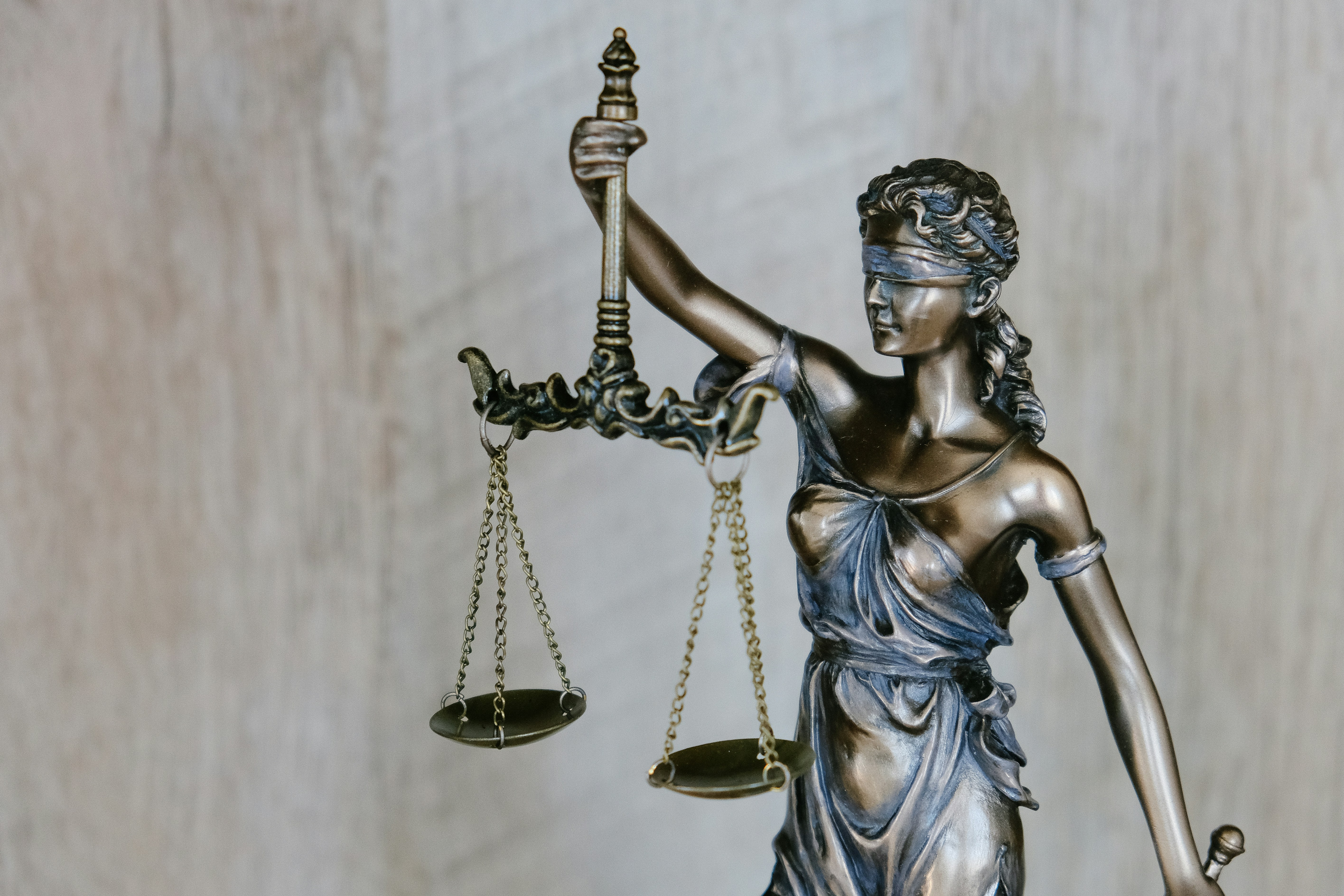 Image of a statue of lady justice wearing blindfold and holding scales 
